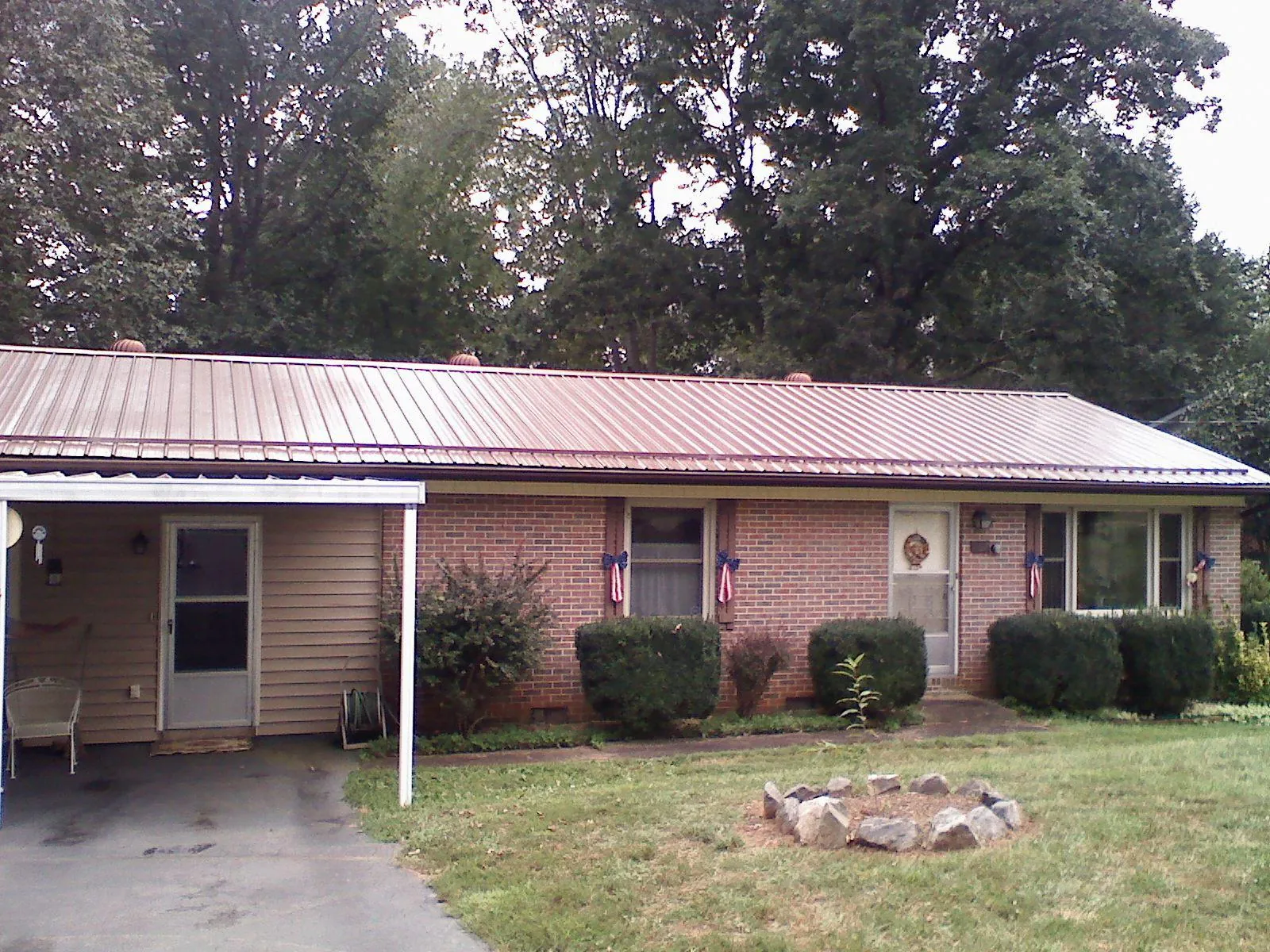 Bronze metal roof and carport on a brick ranch home — Roof Repair work by our crew in Anatone